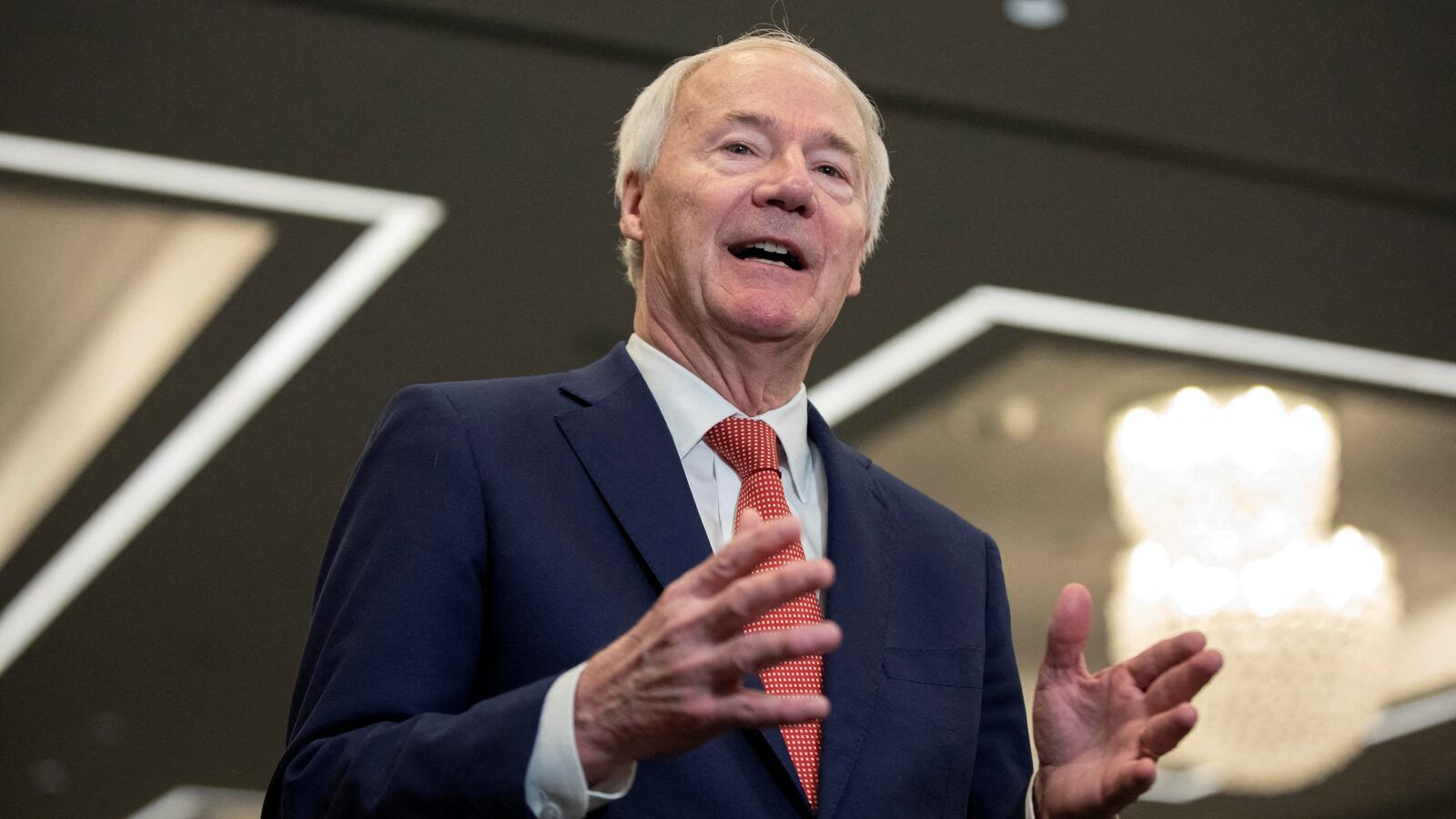 Asa Hutchinson speaks on stage at an event.