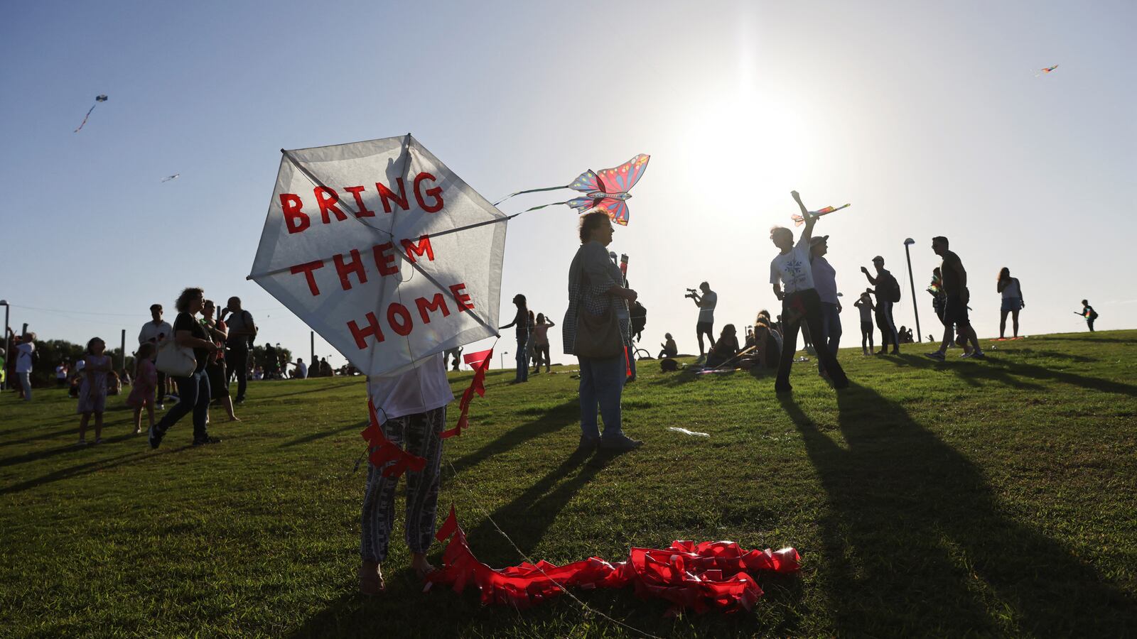 People take part in an event where they fly kites and demand the immediate release of hostages held in Gaza