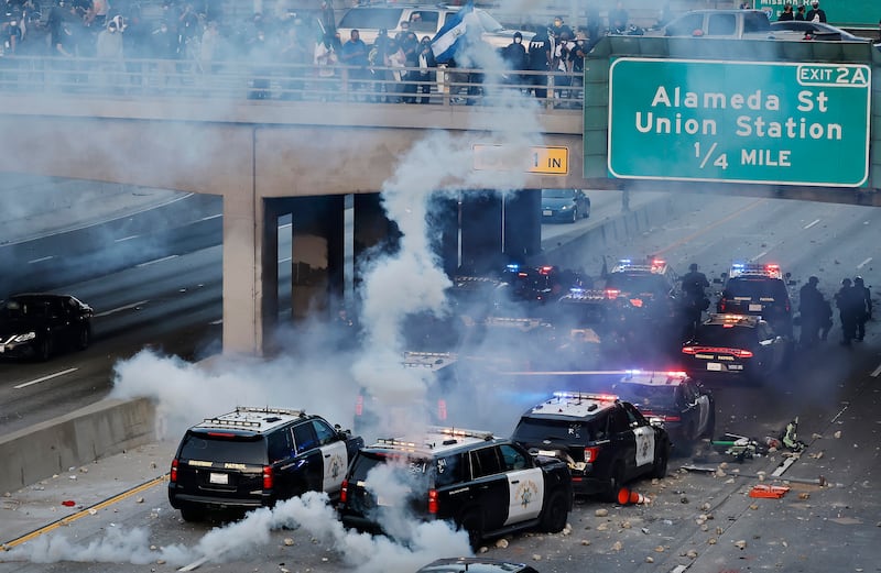 California Highway Patrol (CHP) cars, some damaged, are lined up along the 101 freeway after officers cleared protesters from the area.