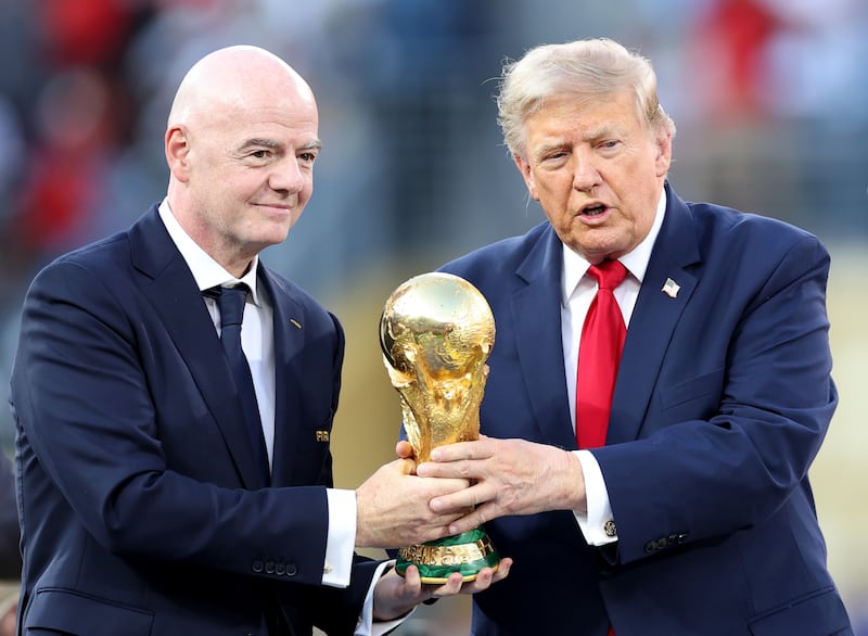 U.S. President Donald Trump and FIFA President Gianni Infantino hold the FIFA World Cup Winner's Trophy before handing it over to captain Rodri #16 of Spain.