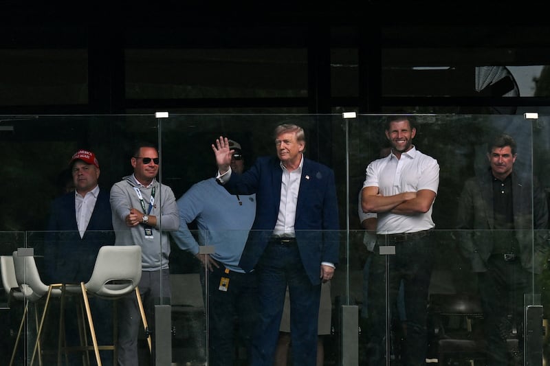 U.S. President Donald Trump waves next to his son Eric Trump as they attend the LIV Golf Tournament at Trump National Golf Club in Sterling, Virginia, U.S., May 9, 2026. REUTERS/Annabelle Gordon REFILE - CORRECTING YEAR FROM "2025" TO "2026\
