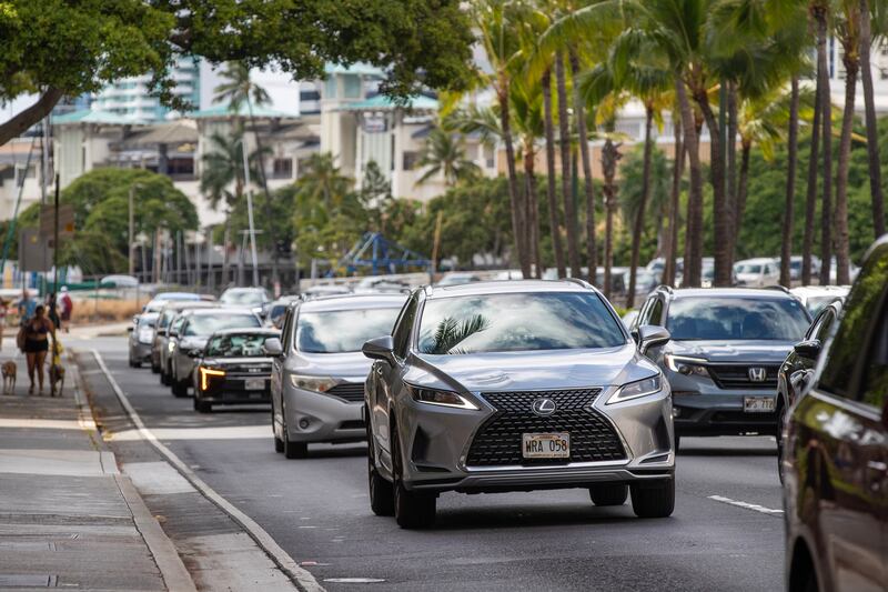Vehicles depart Waikiki beach in Oahu, Hawaii.