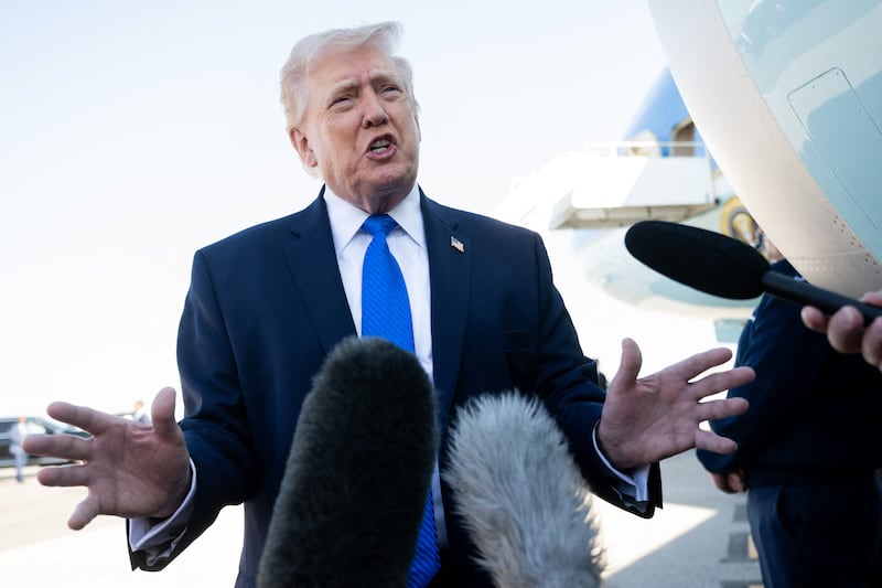 President Donald Trump speaks to reporters before boarding Air Force One at Palm Beach International Airport in West Palm Beach, Florida, on March 23, where he continued to insist Congress needed to pass the SAVE America Act while lawmakers negotiate DHS funding and indicated he would even send in the National Guard if the delays at airports continue after announcing ICE agents would be heading to airports as delays intensify.