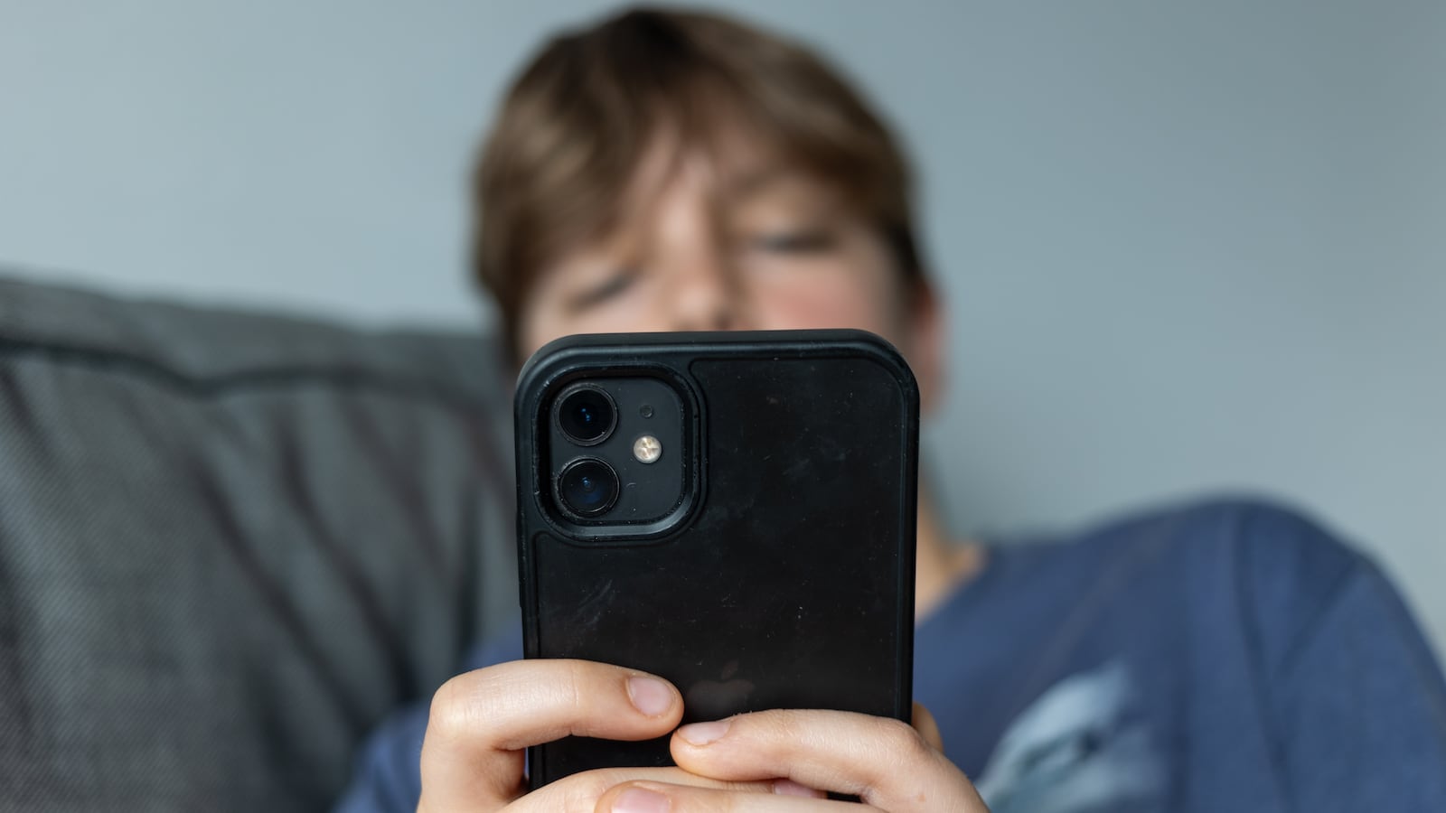 BATH, UNITED KINGDOM - FEBRUARY 09: In this photo illustration 12-year-boy looks at his phone on February 9, 2025 in Bath, England. Recently the Australian Senate passed a law to ban children under 16 from having social media accounts and social media platforms, including TikTok, Facebook, Snapchat, Reddit, X, formerly Twitter, and Instagram potentially being be fined for preventing children younger than 16 from having social media accounts. (Photo by Anna Barclay/Getty Images)