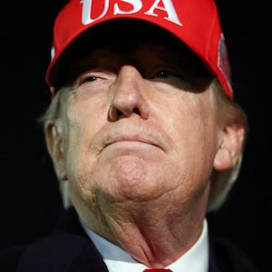 U.S. President Donald Trump looks on after disembarking Air Force One as he arrives at Joint Base Andrews in Maryland, U.S., April 12, 2026.  REUTERS/Kevin Lamarque