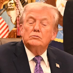 US President Donald Trump (C) and US Secretary of Commerce Howard Lutnick (R) listen as US Senator Ted Cruz (R-TX) (L) speaks during a signing ceremony on AI the Oval Office of the White House in Washington, DC, on December 11, 2025.