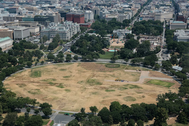 Aerial shots from the Washington Monument show the deconstruction of the temporary UFC arena, as well as significant lawn damage. The construction of the White House ballroom continues.