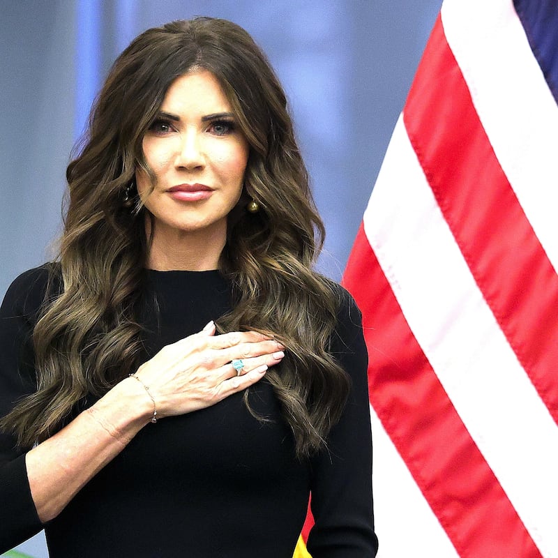Secretary of Homeland Security Kristi Noem stands with Coast Guard Commandant Adm. Kevin E. Lunday