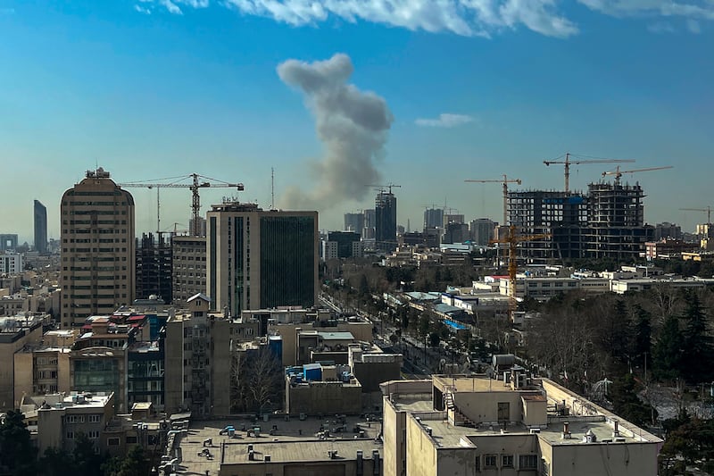 TOPSHOT - A plume of smoke rises following a reported explosion in Tehran on February 28, 2026. Israel's defence ministry announced February 28 it had launched a "preemptive strike" on Iran as sirens sounded in Jerusalem and people across the country received phone alerts about an "extremely serious" threat. (Photo by AFP via Getty Images)