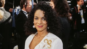 American actress, singer and dancer Jasmine Guy, wearing a white outfit with gold and silver detail, attends the 63rd Academy Awards at the Shrine Auditorium in Los Angeles, California, 25th March 1991. (Photo by Michael Montfort/Michael Ochs Archives/Getty Images)