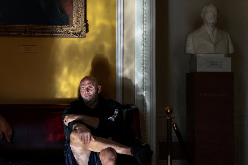 U.S. Senator John Fetterman (D-PA) sits on a bench outside the Senate chamber between votes after the Senate failed to advance proposals that would reduce healthcare costs, on Capitol Hill in Washington, D.C., U.S.,December 11, 2025. REUTERS/Evelyn Hockstein