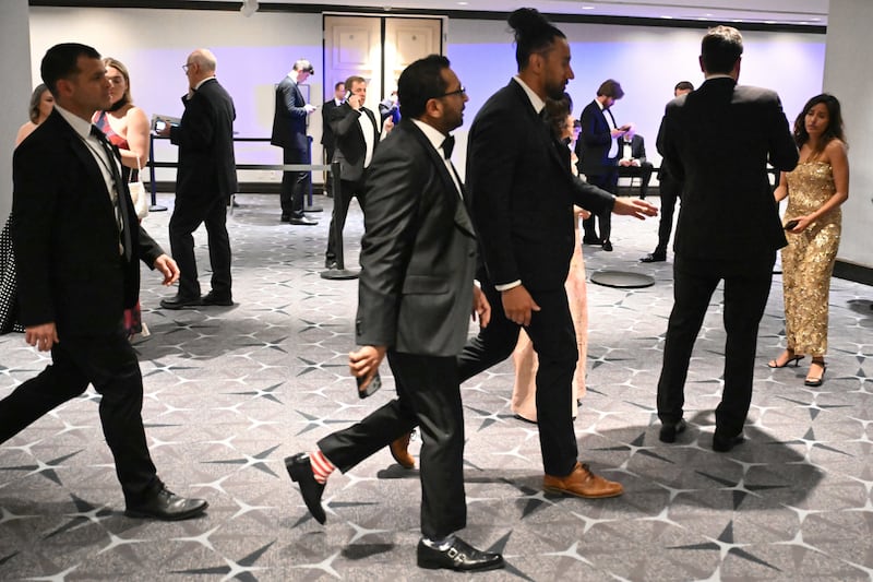 FBI Director Kash Patel (C) walks past after shots were reportedly fired during the White House Correspondents' dinner at the Washington Hilton in Washington, DC, on April 25, 2026. Shots were allegedly fired as US President Donald Trump attended a press dinner in Washington on Saturday night, witnesses and AFP reporters said as loud bangs were heard at the hotel venue.