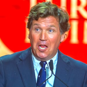 Tucker Carlson speaks during the memorial service for political activist Charlie Kirk at State Farm Stadium on September 21, 2025 in Glendale, Arizona.