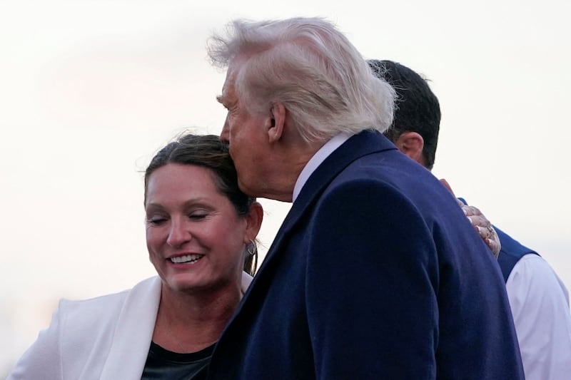 U.S. Senator Markwayne Mullin (R-OK) and his wife Christie Mullin welcome U.S. President Donald Trump at Philadelphia International Airport in Philadelphia, Pennsylvania, U.S., March 22, 2025. REUTERS/Nathan Howard