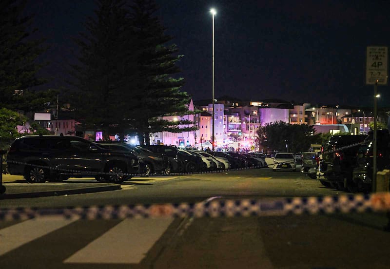 Police set up a cordon line at the scene of the mass shooting at Bondi Beach .