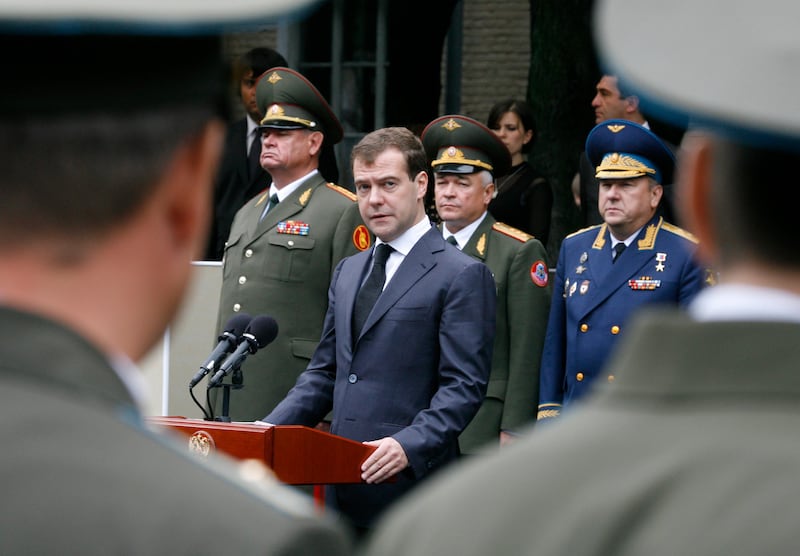 Russia's President Dmitry Medvedev (C) talks as he visits a Russian military unit in Vladikavkaz August 8, 2009. Silent tribute and bitter accusation marked the first anniversary on Friday of Georgia's war with Russia over breakaway South Ossetia, where unresolved tensions threaten new hostilities.