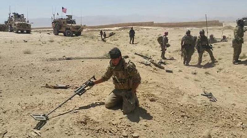 Abdul Rahman Waziri searching for improvised explosive devices in Afghanistan.