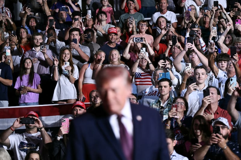 Supporters react as US President Donald Trump arrives to speak during a midterm campaign rally at The Mitchell Center of the University of South Alabama in Mobile, Alabama on October 2, 2026.
