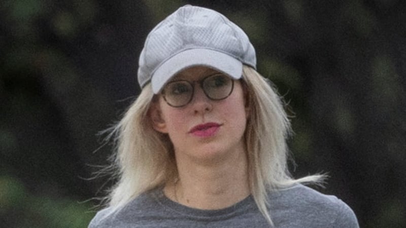 Theranos founder Elizabeth Holmes carries hand weights while walking on the track at the Federal Prison Camp in Bryan, Texas, U.S., August 2, 2025. REUTERS/Adrees Latif