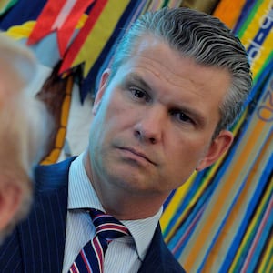 WASHINGTON, DC - AUGUST 25: U.S. Defense Secretary Pete Hegseth listens to President Donald Trump talk to journalists after signing executive orders in the Oval Office at the White House on August 25, 2025 in Washington, DC. Furthering his federal takeover of the capital city’s law enforcement, Trump signed orders ending cashless bail in the District of Columbia, mandating prosecution for people who desecrate the American flag -- including by burning it -- and other orders. (Photo by Chip Somodevilla/Getty Images)
