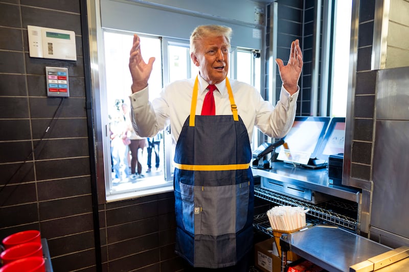 Republican presidential nominee, former U.S. President Donald Trump works behind the counter during a campaign event at McDonald's restaurant on October 20, 2024 in Feasterville-Trevose, Pennsylvania.