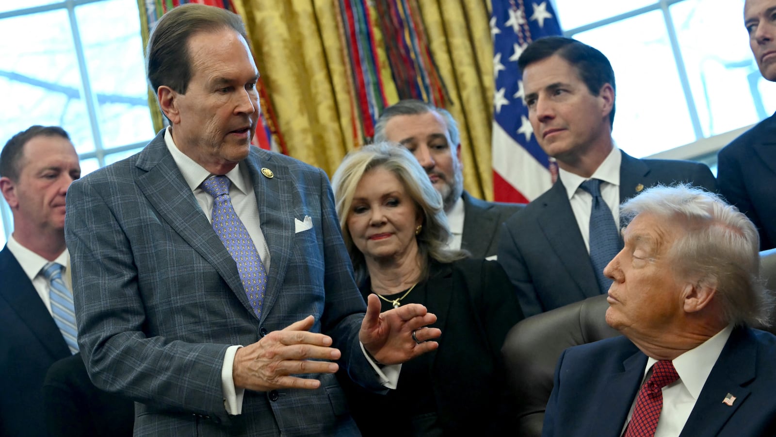 US Representative Vern Buchanan (L), Republican of Florida, speaks as President Donald Trump makes an announcement from the Oval Office of the White House in Washington, DC on December 3, 2025. President Trump announced weaker fuel efficiency standards for the country, as part of his agenda to lower the price of gasoline-powered cars. (Photo by ANDREW CABALLERO-REYNOLDS / AFP via Getty Images)