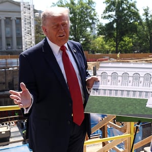 President Donald Trump shows images of the concept at the site of the ongoing construction of the planned White House ballroom in Washington, D.C., on May 19, 2026.