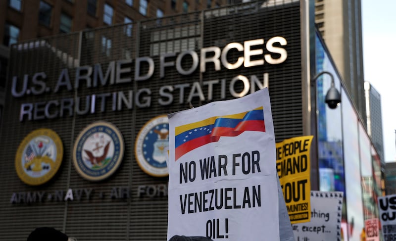 People demonstrate against US military action in Venezuela in Times Square on January 3. 2026 in New York.