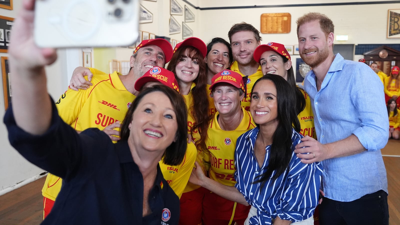 Meghan, Duchess of Sussex and Prince Harry, Duke of Sussex pose for a selfie photo as they meet volunteer first responders from Bondi Surf Bathers' Life Saving Club, during a visit to Bondi Beach, on day four of the royal trip to Australia on April 17, 2026 in Sydney, Australia. Volunteers from the organization, founded in 1907, played an integral role in protecting beachgoers and saving lives during the terrorist attack at Bondi Beach on December 14.