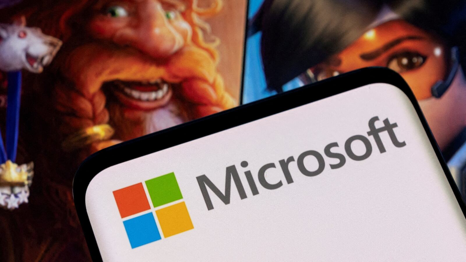 Microsoft logo is seen on a smartphone placed on displayed Activision Blizzard’s games characters in this illustration taken Jan. 18, 2022.