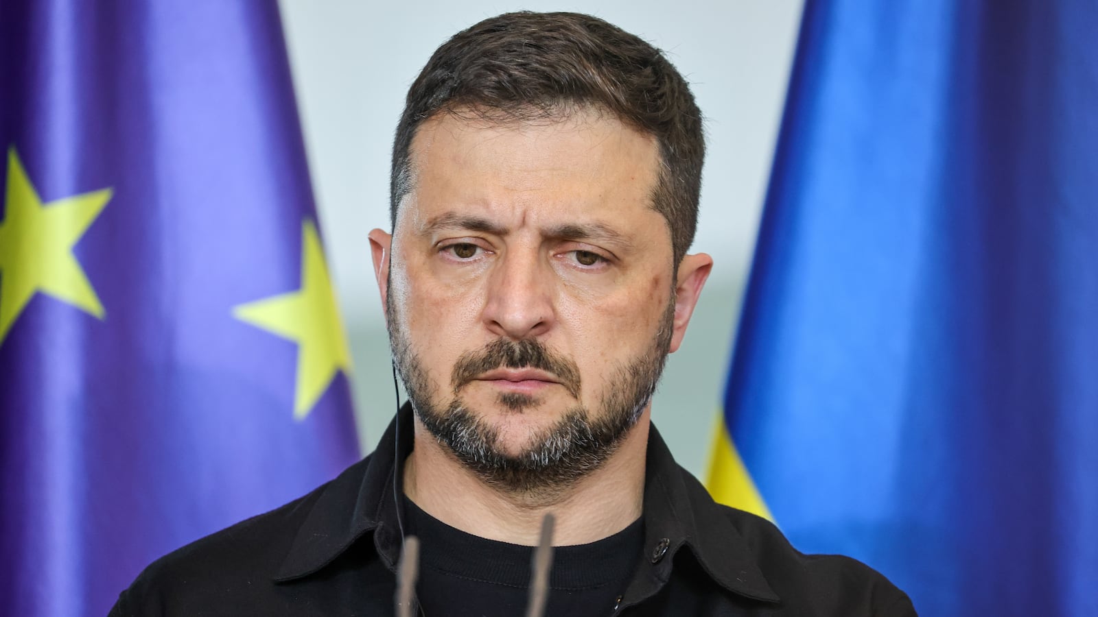 BERLIN, GERMANY - AUGUST 13: Ukrainian President Volodymyr Zelensky listens as German Chancellor Friedrich Merz (not pictured) speaks during a joint press conference at the Chancellery following a virtual meeting hosted by Merz between European leaders and U.S. President Donald Trump on August 13, 2025 in Berlin, Germany. The meeting was meant to clarify the European position prior to talks scheduled for Friday between Trump and Russian President Vladimir Putin in Alaska on reaching an end to the Russian war in Ukraine. (Photo by Omer Messinger/Getty Images)