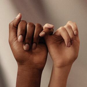 A couple holding each other's pinky.