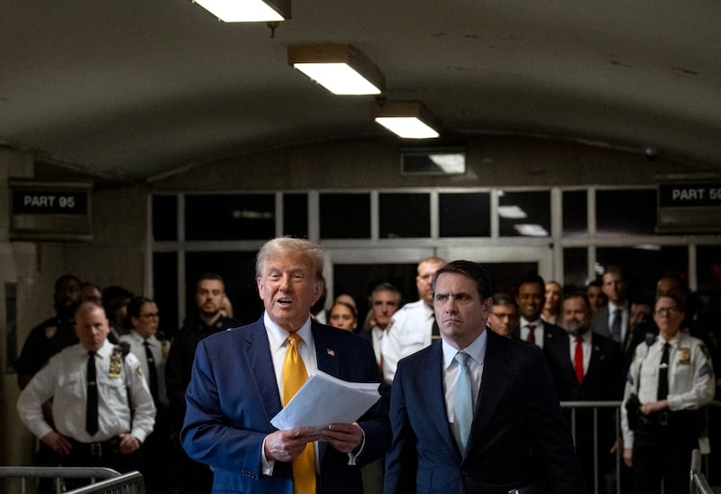 Former US President Donald Trump, with lawyer Todd Blanche (R), speaks to the press as he arrives to attend his trial for allegedly covering up hush money payments linked to extramarital affairs, at Manhattan Criminal Court in New York City, on May 14, 2024.