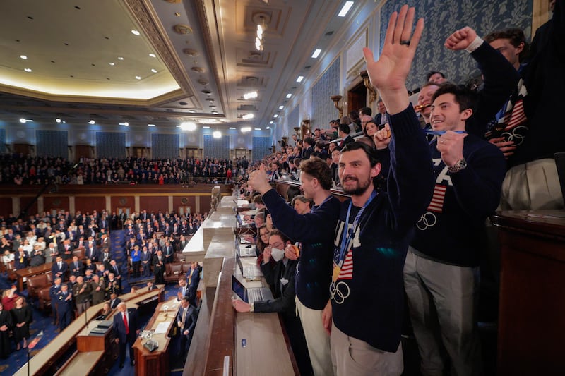 Members of the Team USA Men's Hockey Team, including goalie Connor Hellebuyck, wave to the audience as U.S. President Donald Trump delivers his State of the Union address during a Joint Session of Congress at the U.S. Capitol on February 24, 2026, in Washington, DC.