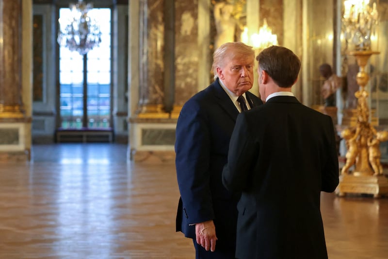 U.S. President Donald Trump speaks with President of France Emmanuel Macron as he receives a tour of Chateau de Versailles ahead of a dinner, France, June 17, 2026.
