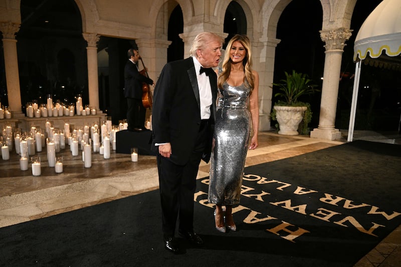 US President Donald Trump and First Lady Melania Trump attend the New Year's Eve Party at his Mar-a-Lago residence in Palm Beach, Florida on December 31, 2025. (Photo by Jim WATSON / AFP via Getty Images)