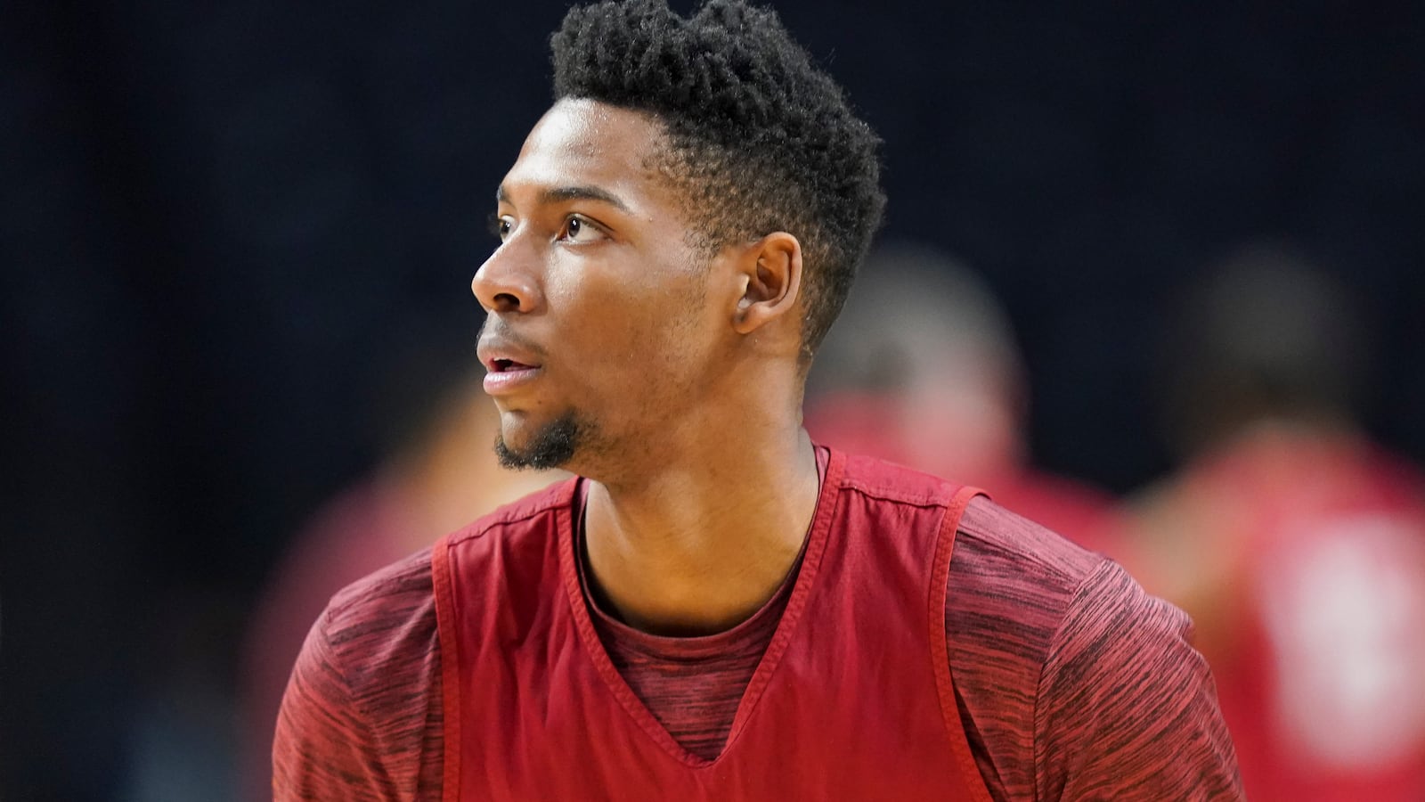 Side profile of Brandon Miller on a basketball court in practice gear.