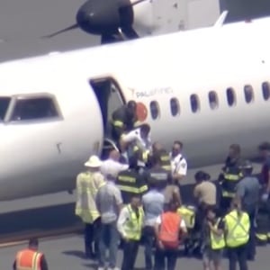 Passengers and pilot disembarking from the plane.