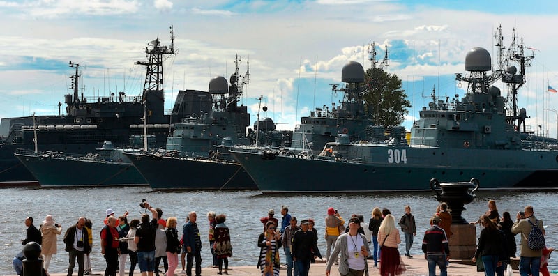 Tourists take pictures in front of warships at a Russian Navy base in the town of Kronstadt outside Saint Petersburg on July 18, 2017. 
The Naval Military Parade will be held in Saint Petersburg on the Navy Day on July 30. / AFP PHOTO / Olga MALTSEVA        (Photo credit should read OLGA MALTSEVA/AFP via Getty Images)