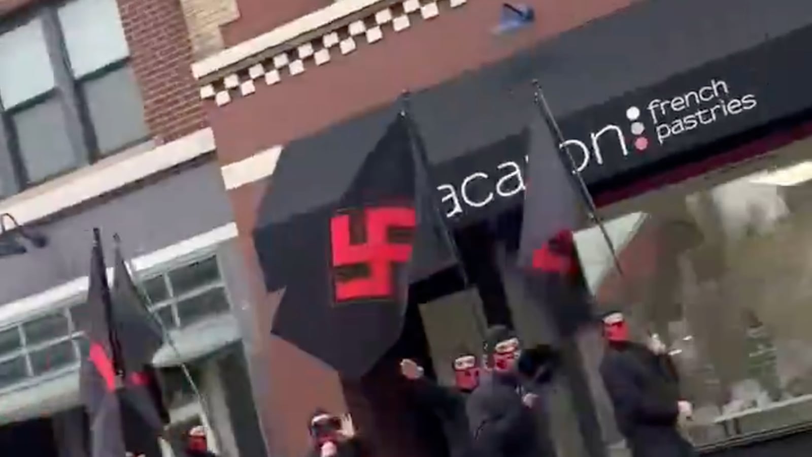 A video still shows a group of neo-Nazis marching in downtown Columbus, Ohio.