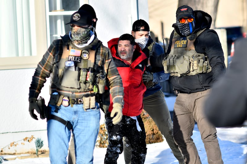 Federal immigration agents detain a man during an operation by ICE and Border Patrol in St. Paul, Minnesota, on January 27. DHS is outsourcing some of its tracking and surveillance efforts to pricate companies, according to a report.
