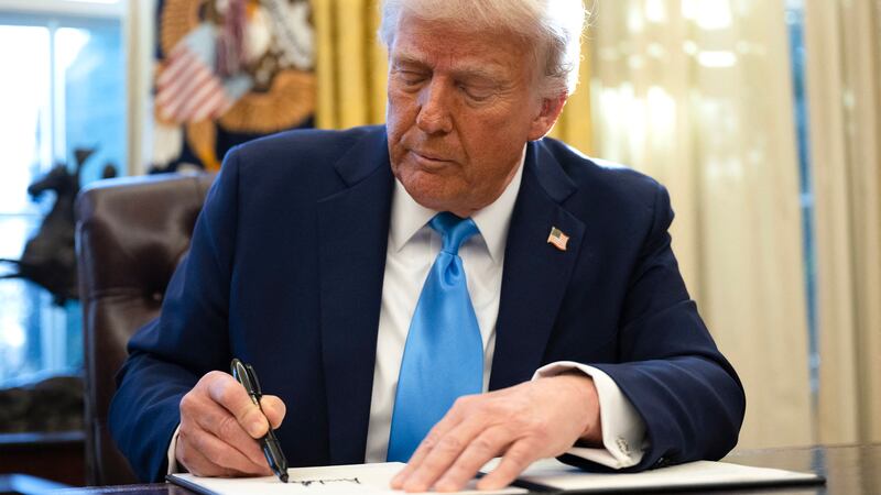 President Donald Trump signs an executive order withdrawing his country from a number of United Nations bodies in the Oval Office of the White House on February 4, 2025 in Washington, DC.