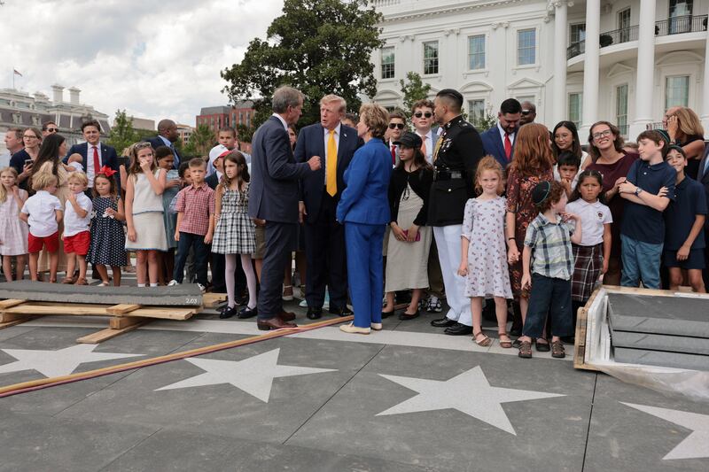 Trump, Secretary of Education Linda McMahon, and Nebraska Governor Jim Pillen were joined at the helipad by families who attended a back-to-school-themed event.