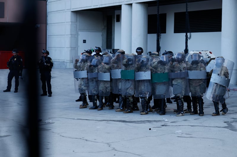 National Guard and DHS Police gather outside the back entrance of the Edward R. Roybal Federal Building as demonstrators gather outside the building barricades to advocate for immigrant rights on Labor Day, Monday, Sept. 1, 2025 in Los Angeles, CA.