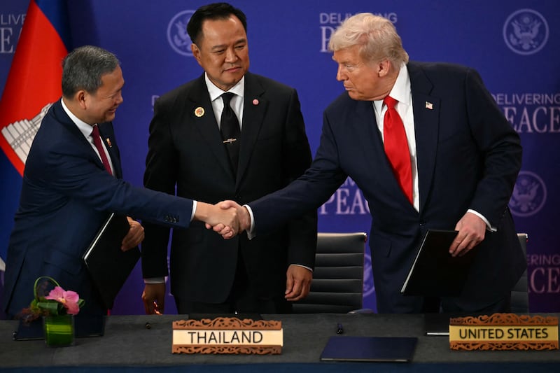 Thailand's Prime Minister Anutin Charnvirakul watches as Cambodia's Prime Minister Hun Manet (L) and US President Donald Trump (R) shake hands on the sidelines of the 47th Association of Southeast Asian Nations (ASEAN)