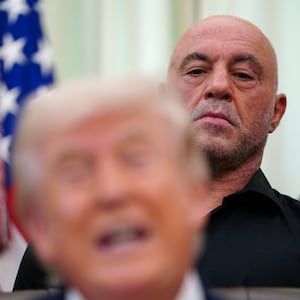 Joe Rogan stands next to U.S. President Donald Trump in the Oval Office of the White House in Washington, D.C., April 18, 2026. REUTERS/Nathan Howard