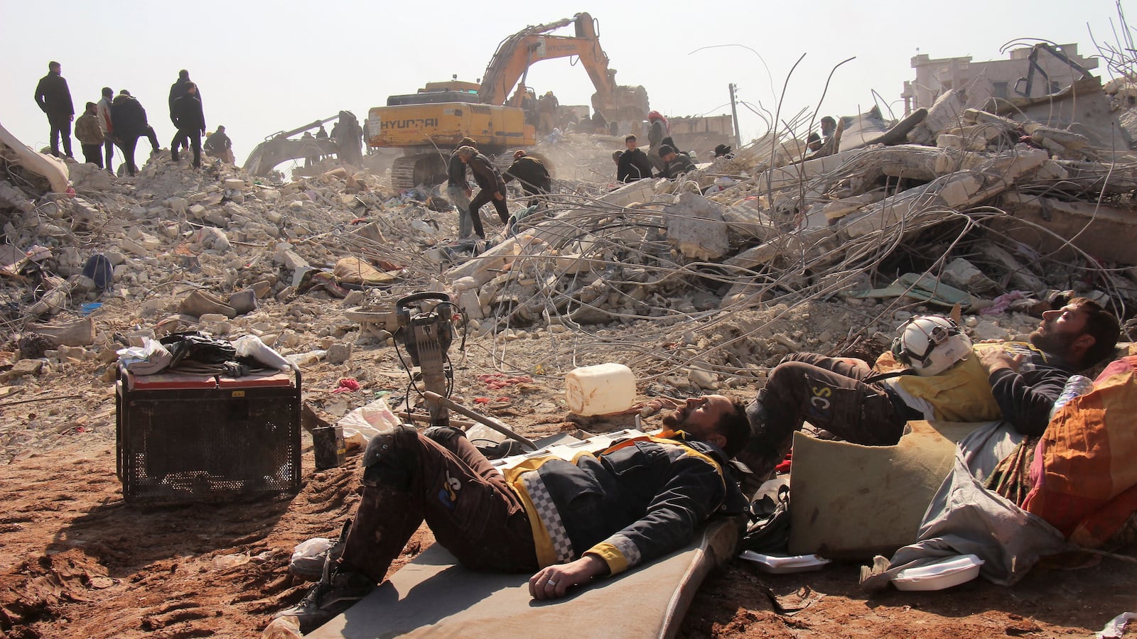 White Helmets members rest on day five of the rescue operations after a massive earthquake in Jandaris, Syria, Feb. 10, 2023.