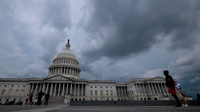 Storm clouds over the Capitol on Tuesday, shortly after the Senate passed its version of Trump's bill.