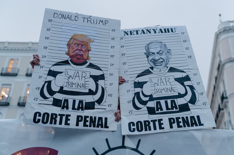 MADRID, SPAIN - MARCH 21: Protesters hold signs during an anti-war demonstration on March 21, 2026 in Madrid, Spain. Around 4,000 people have demonstrated in this protest, which organizers described as anti-Trump and anti-Zionism and comes as the United States and Israel continue their joint conflict against Iran. (Photo by Olmo Blanco/Getty Images)