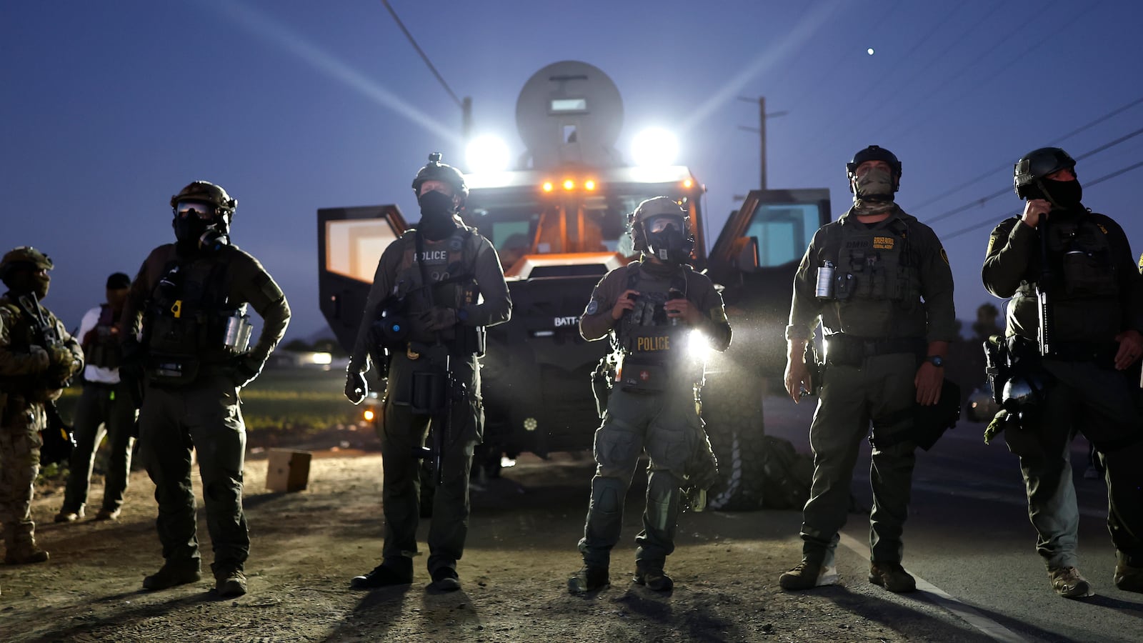 Federal agents block people protesting an ICE immigration in California.